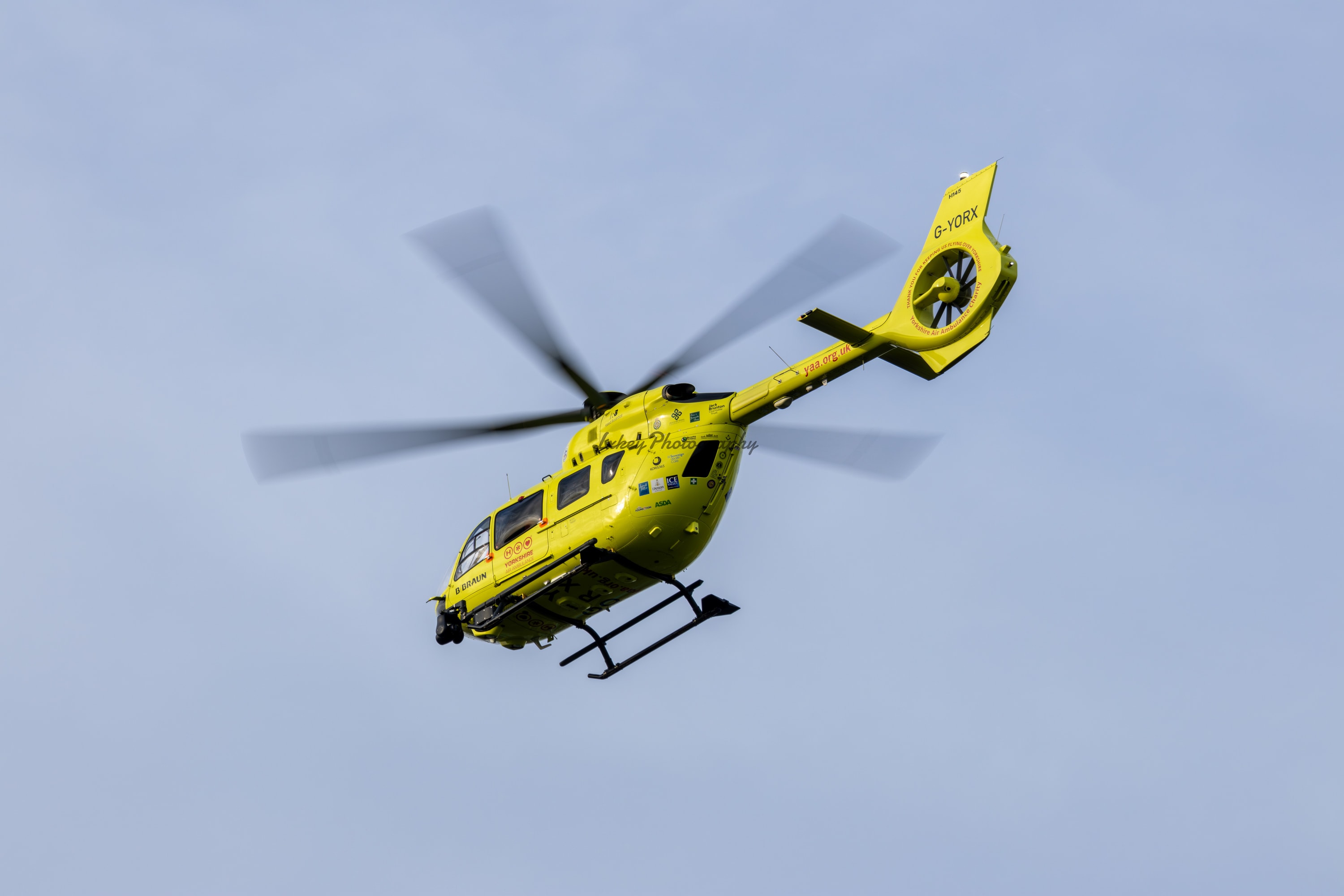 Air ambulance helicopter climbing away after a callout