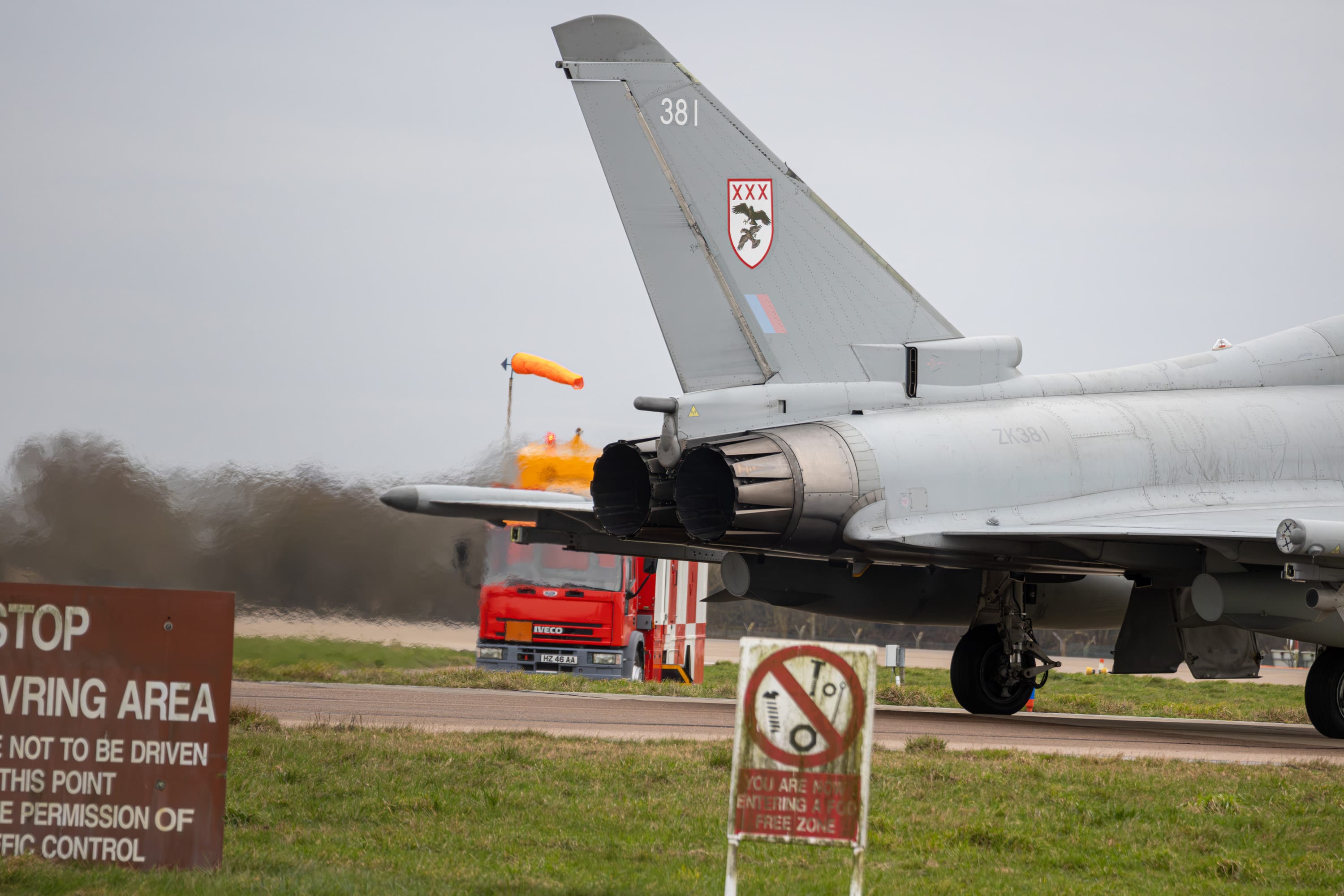 RAF Eurofighter Typhoon at the runway holding point with heat haze from the exhausts