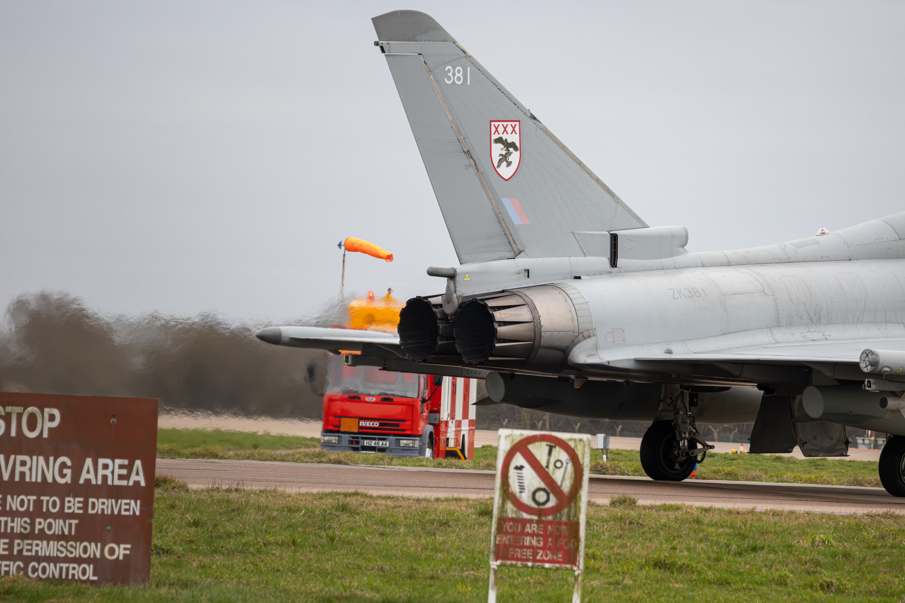 RAF Eurofighter Typhoon at the runway holding point with heat haze from the exhausts