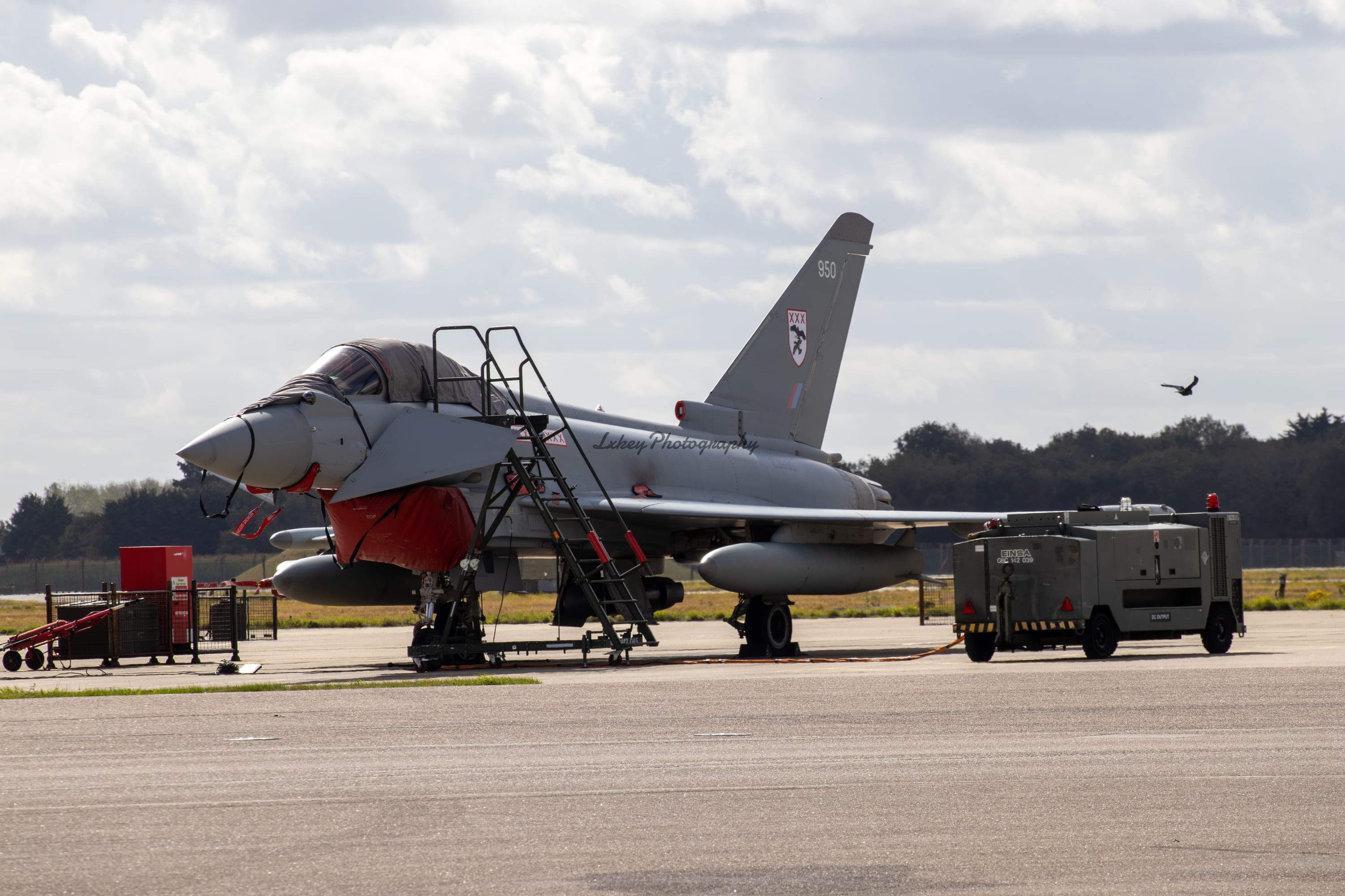 RAF Eurofighter Typhoon parked on a wet apron under grey skies
