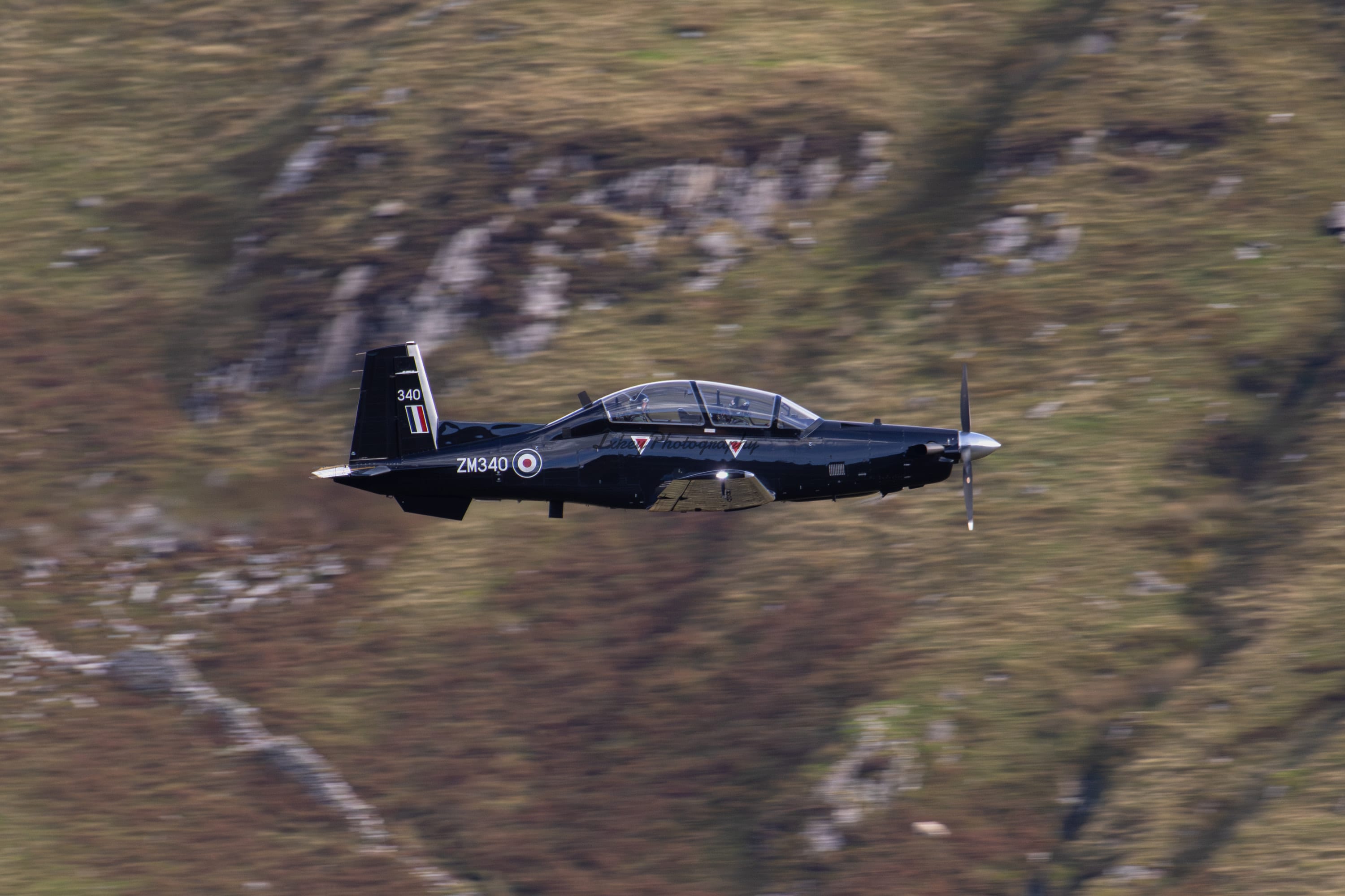 Royal Air Force Beechcraft Texan T1 ZM340 flying low through the Mach Loop in Wales