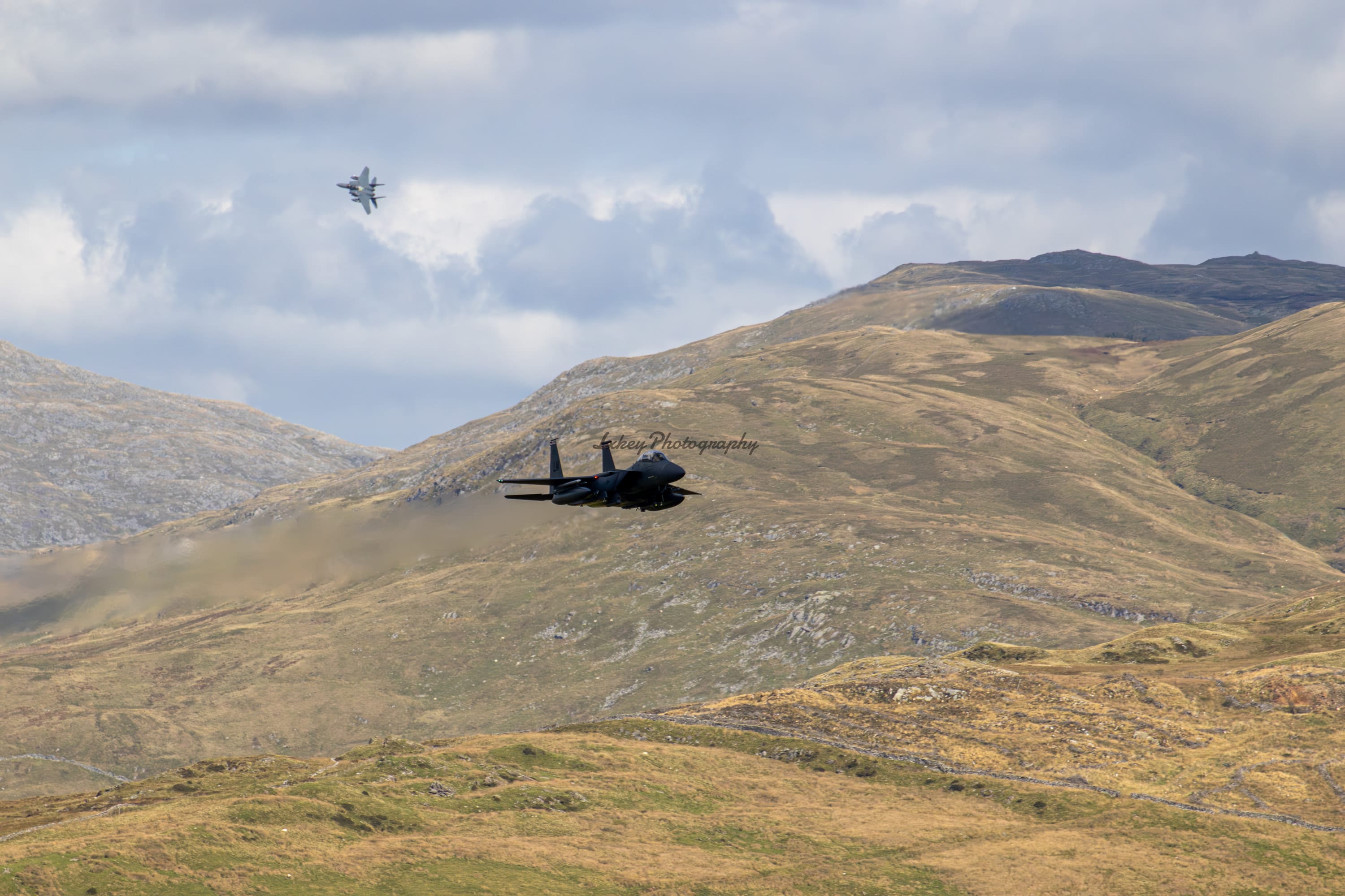 Pair of United States Air Force F-15E Strike Eagles flying low through the Mach Loop in Wales