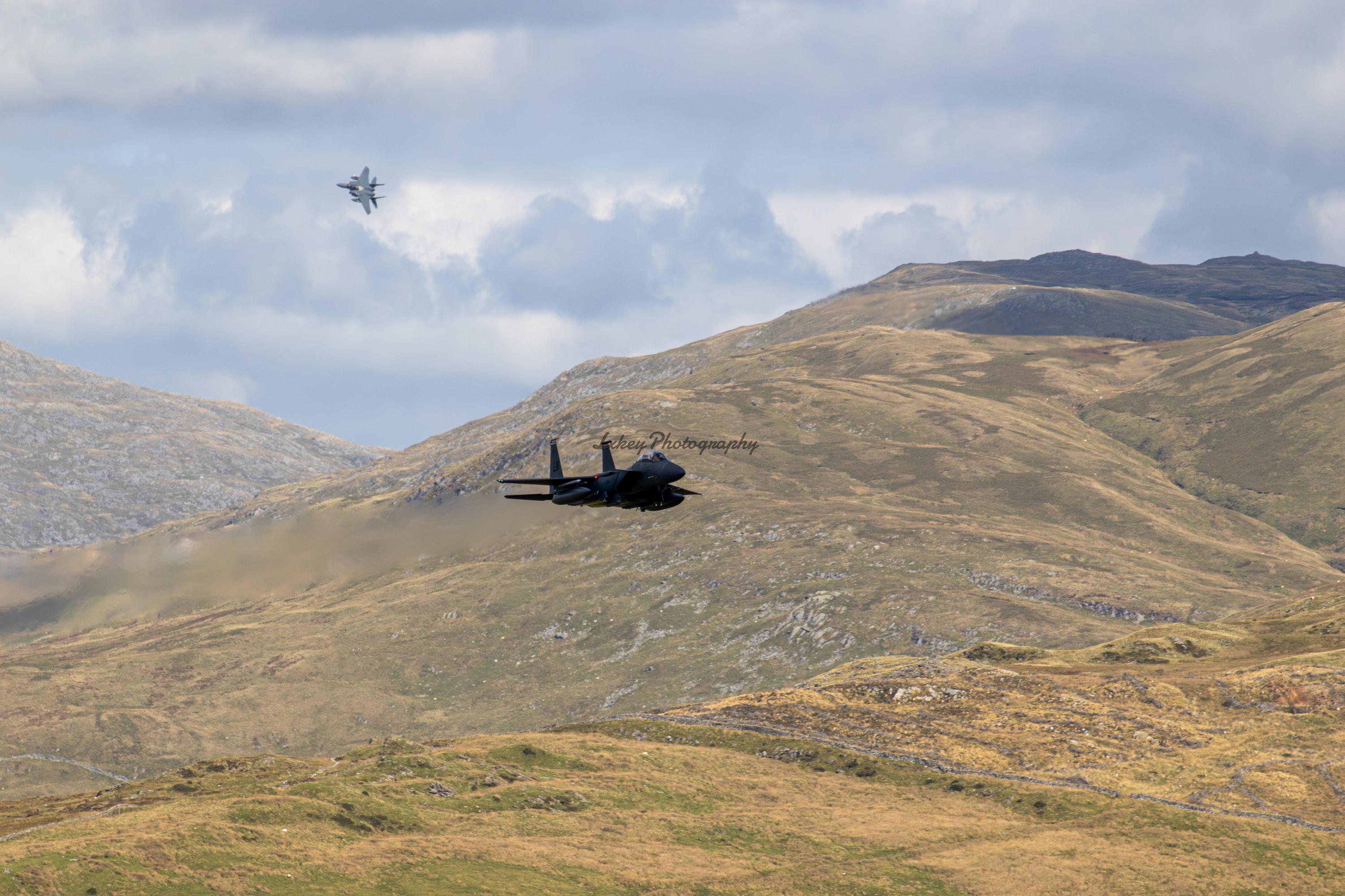 Pair of United States Air Force F-15E Strike Eagles flying low through the Mach Loop in Wales